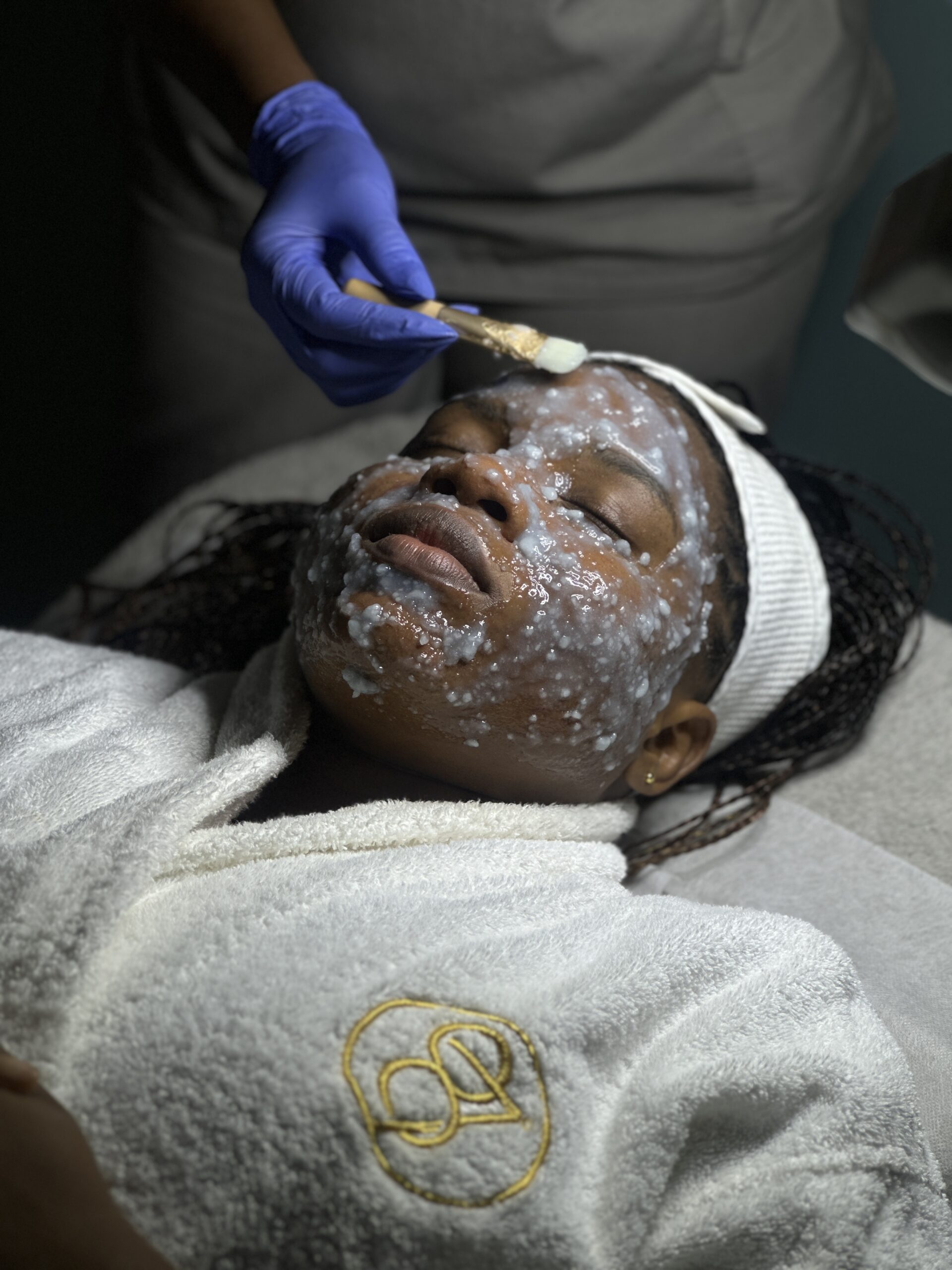 Expert esthetician performing advanced facial treatment in Lagos spa clinic